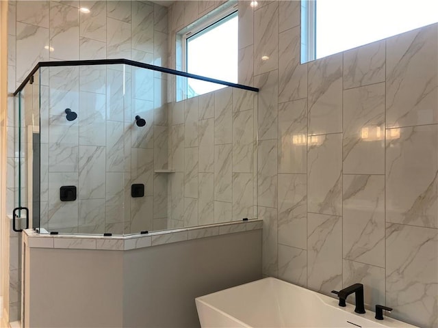full bath with a freestanding tub and a stall shower