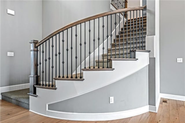 stairway with hardwood / wood-style flooring