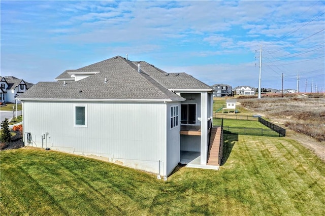 view of property exterior featuring a sunroom and a yard