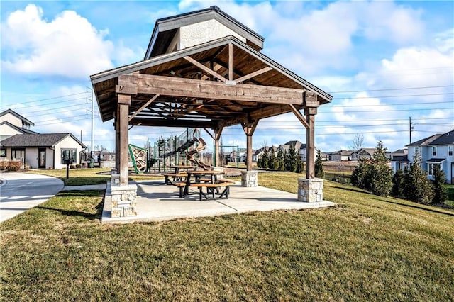 view of community featuring a yard and a patio