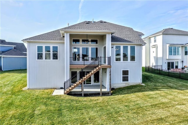 back of property featuring a lawn and a patio