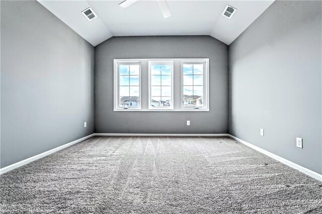 unfurnished room with carpet and lofted ceiling