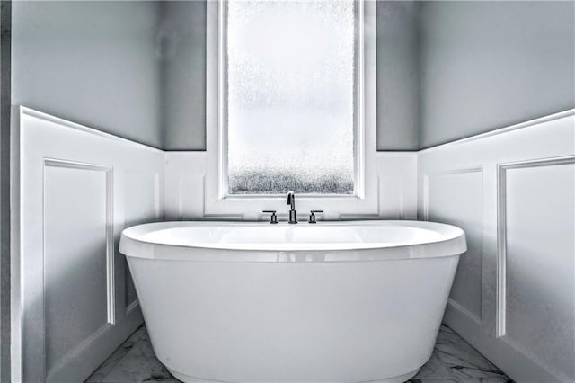 bathroom with a tub to relax in