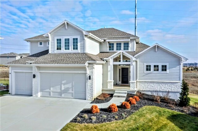 view of front of house with a garage and a front yard