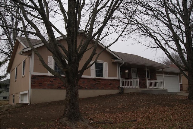 view of front facade with a porch and a garage