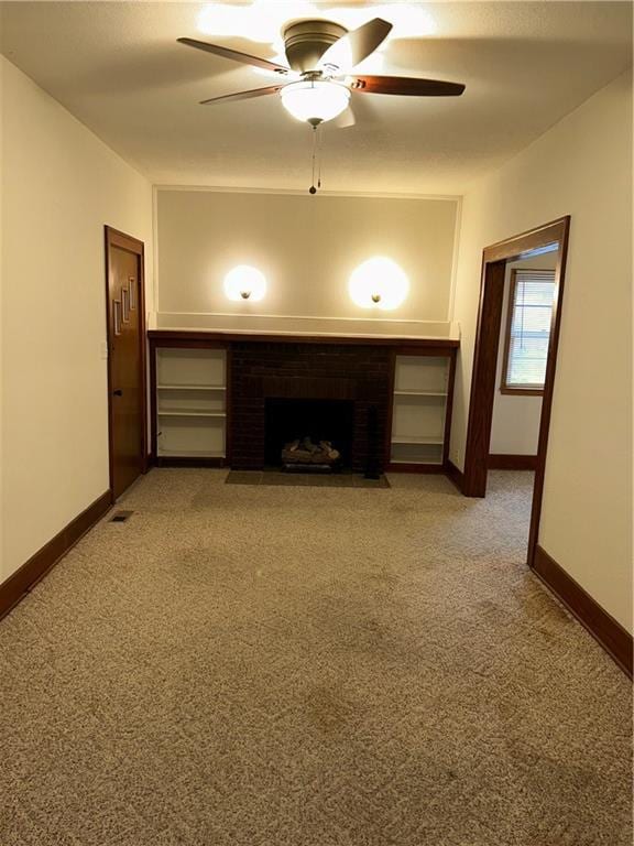 unfurnished living room featuring ceiling fan, a fireplace, and carpet