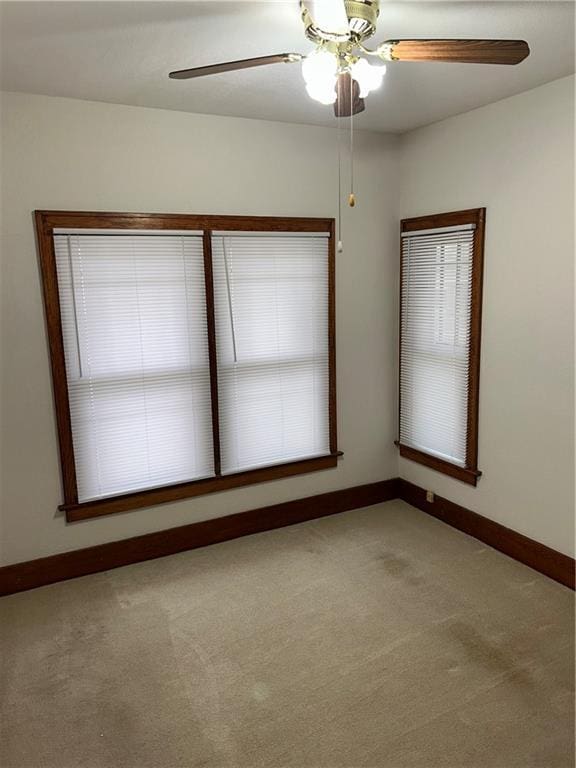 unfurnished room with ceiling fan and light colored carpet