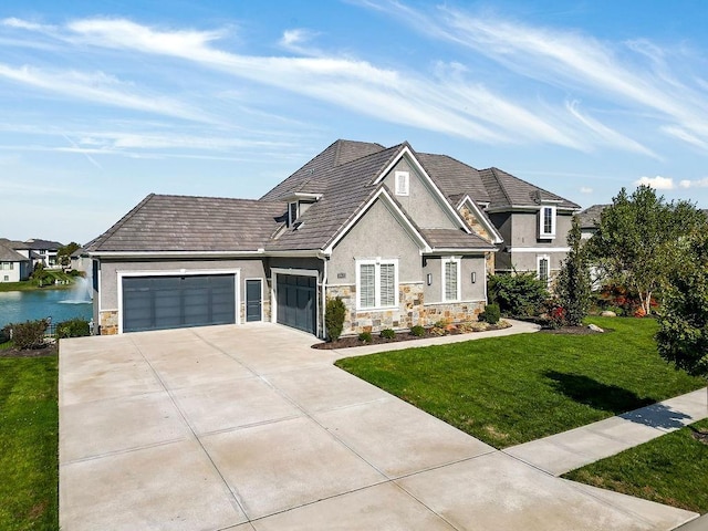 view of front of property with stucco siding, an attached garage, a front yard, stone siding, and driveway