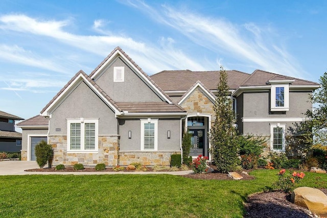 view of front of property featuring stone siding, a front lawn, and stucco siding