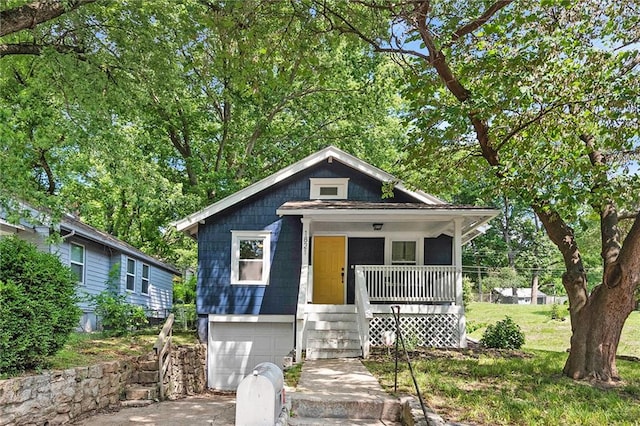 bungalow-style home with a porch and a garage