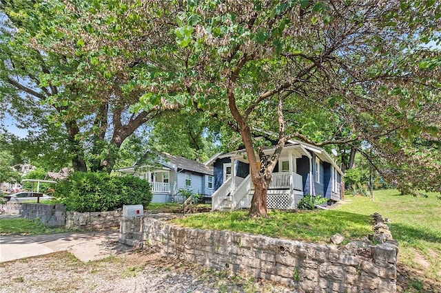 view of front of house with a front yard and a porch