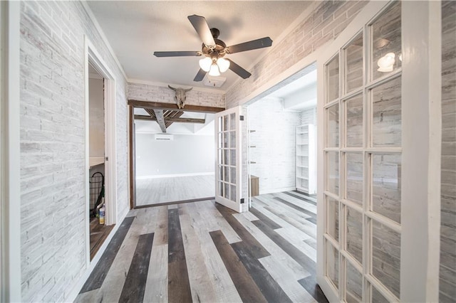 interior space featuring french doors, dark hardwood / wood-style flooring, ceiling fan, and beam ceiling