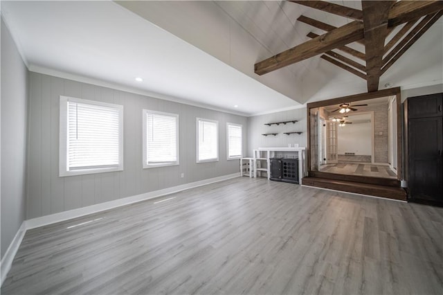 unfurnished living room with lofted ceiling with beams, ceiling fan, wood-type flooring, and ornamental molding