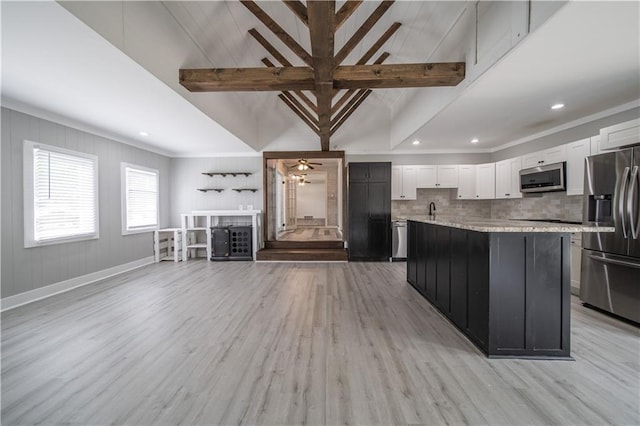 kitchen featuring appliances with stainless steel finishes, sink, a center island, light hardwood / wood-style floors, and white cabinetry