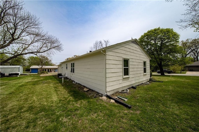 view of side of property with a yard