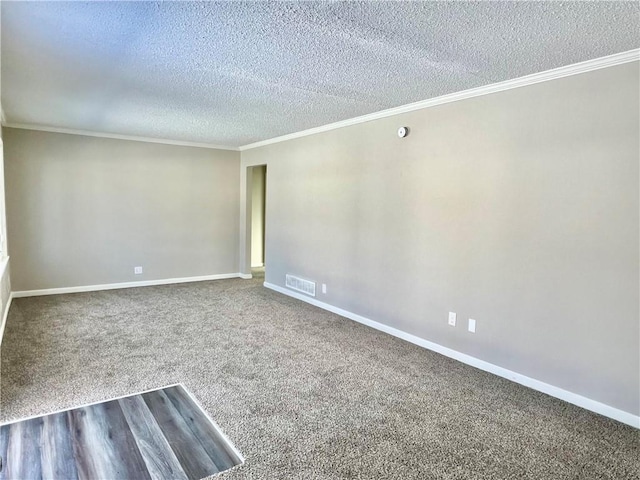 carpeted spare room featuring a textured ceiling and crown molding