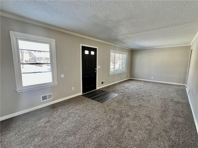 carpeted entryway with a textured ceiling and ornamental molding