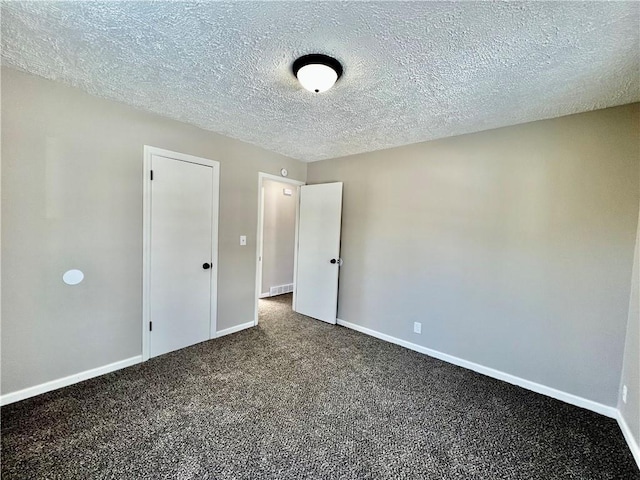 unfurnished bedroom with a textured ceiling and carpet floors