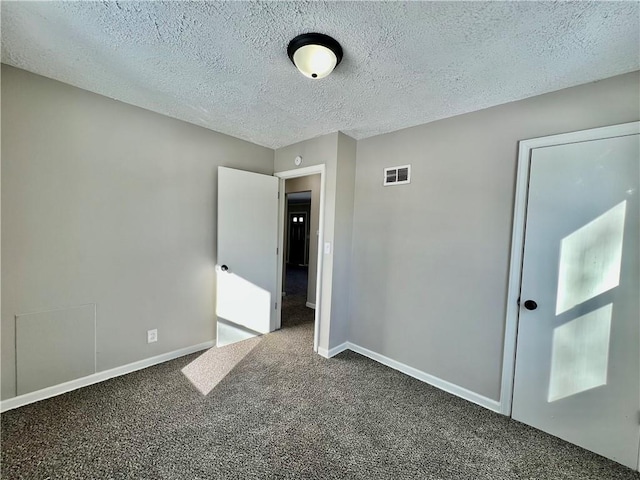 unfurnished bedroom with carpet and a textured ceiling