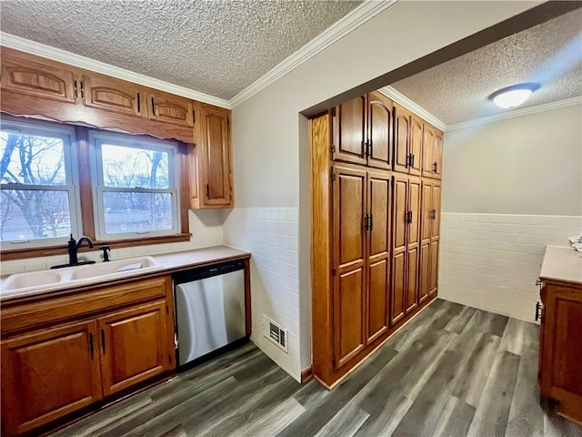 kitchen with a textured ceiling, sink, dark hardwood / wood-style floors, ornamental molding, and stainless steel dishwasher