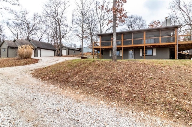 rear view of house featuring a sunroom