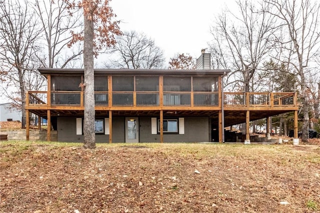 back of house featuring a sunroom