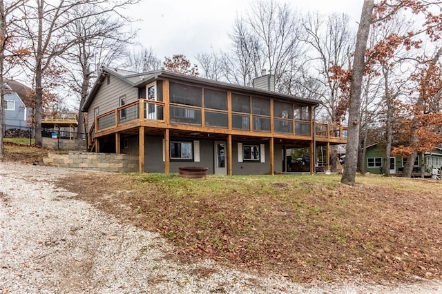 back of house featuring a sunroom