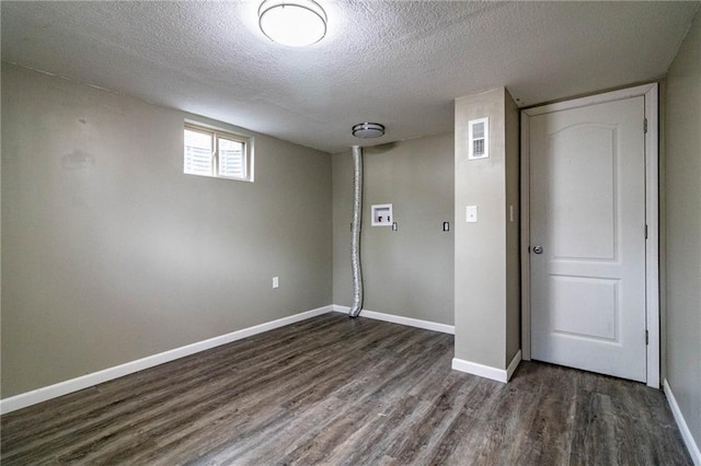 basement with dark hardwood / wood-style flooring and a textured ceiling