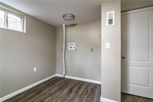 laundry room with hookup for a washing machine, a textured ceiling, and dark hardwood / wood-style floors