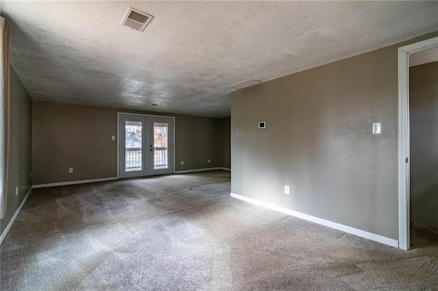 carpeted empty room featuring french doors