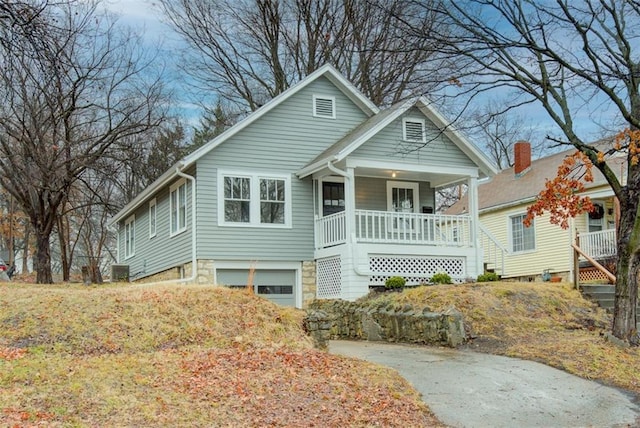 view of front of home with covered porch and a garage