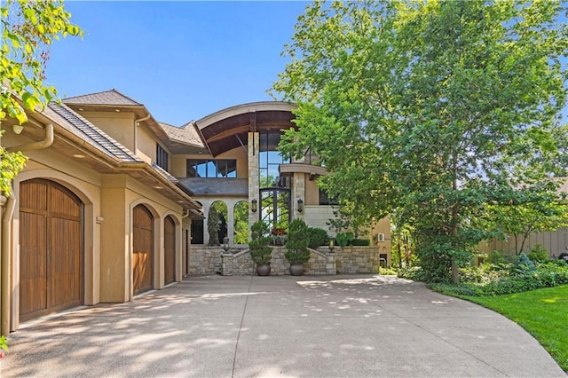 exterior space featuring concrete driveway and stucco siding