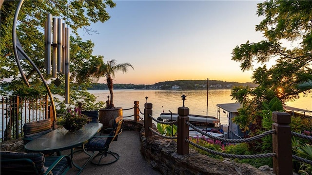 exterior space with a water view and a dock