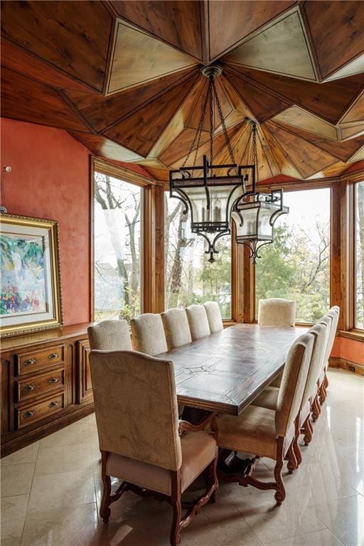 sunroom featuring a notable chandelier