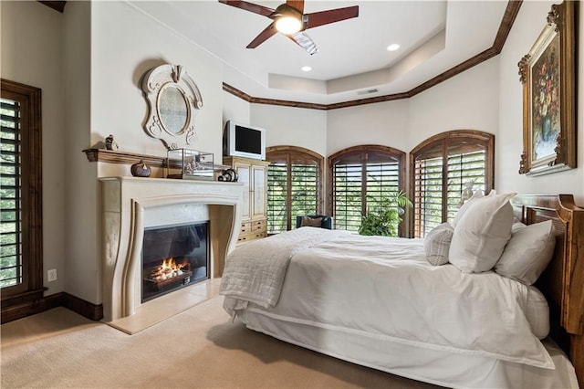 472 N Winnebago Dr, Lake Winnebago, MO 64034 - carpeted bedroom featuring a glass covered fireplace, a raised ceiling, baseboards, ornamental molding, and recessed lighting