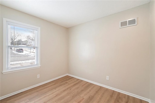 spare room with light hardwood / wood-style floors