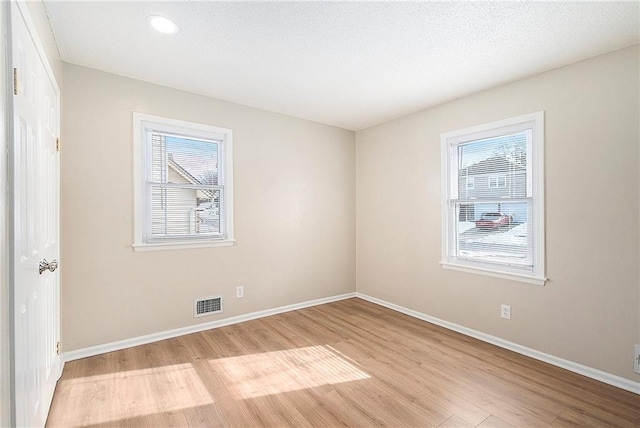 spare room featuring light hardwood / wood-style flooring