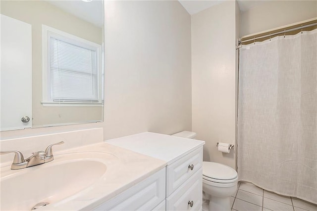 bathroom with vanity, tile patterned floors, and toilet