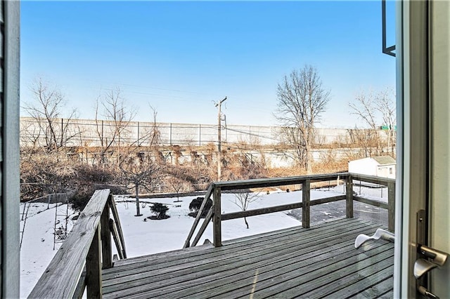 view of snow covered back of property