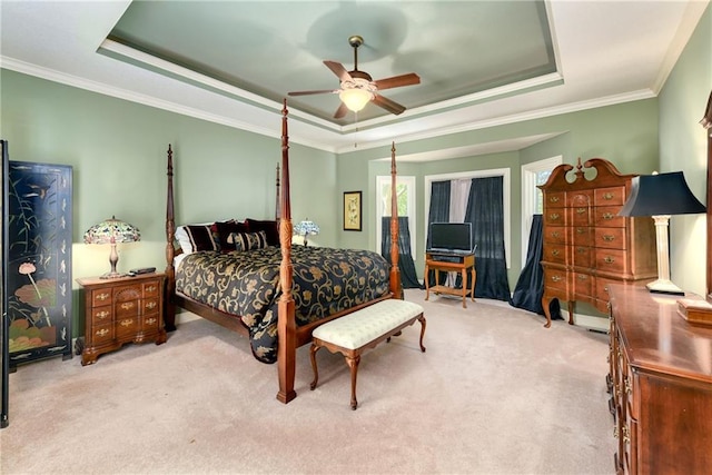 bedroom featuring ornamental molding, carpet, and a raised ceiling