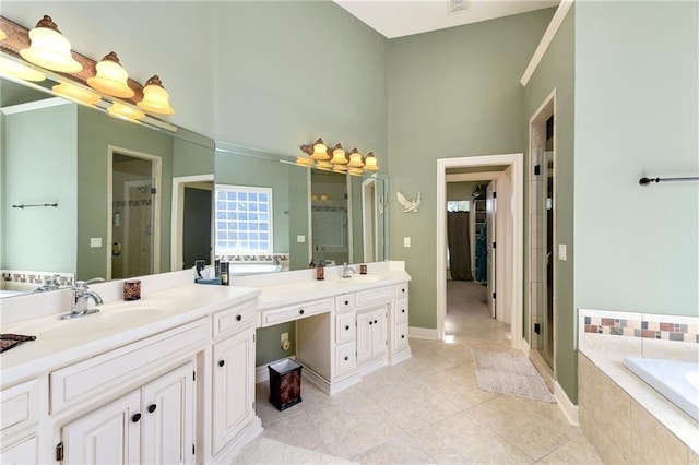 bathroom with a stall shower, a sink, and tile patterned floors