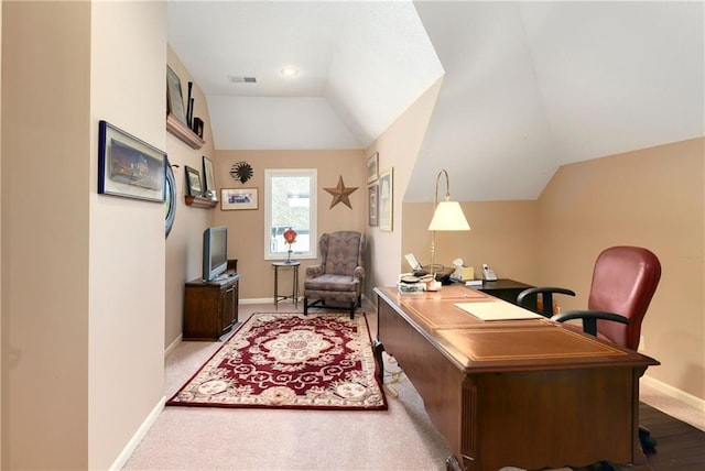 office space with lofted ceiling, light carpet, visible vents, and baseboards