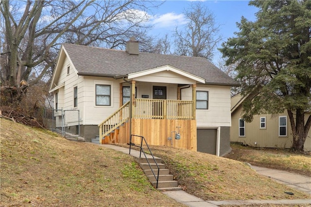 view of front of home with a porch and a garage