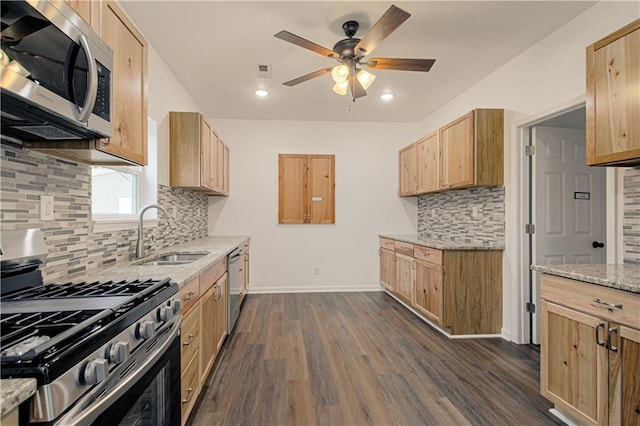 kitchen with light brown cabinetry, sink, stainless steel appliances, and dark wood-type flooring