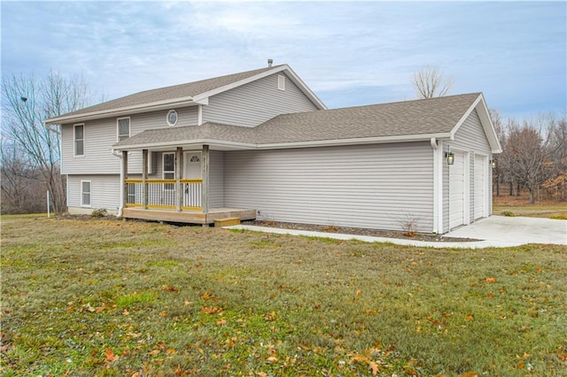 view of front facade with a porch, a garage, and a front lawn