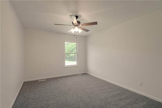 carpeted empty room featuring a textured ceiling and ceiling fan