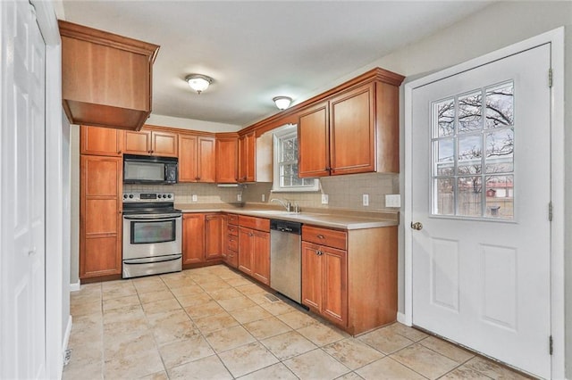 kitchen featuring decorative backsplash, sink, light tile patterned flooring, and appliances with stainless steel finishes