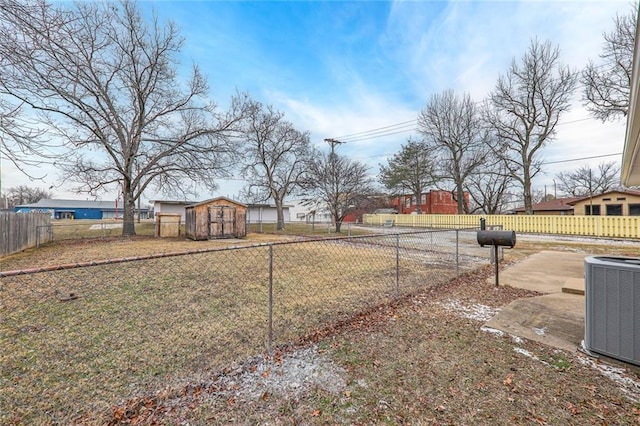 view of yard featuring central AC and a shed