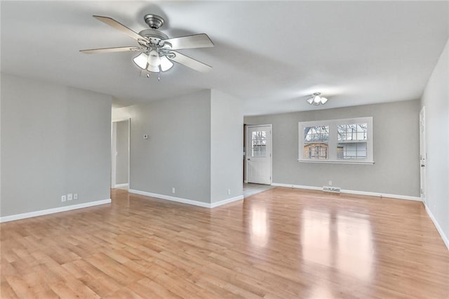 empty room with light hardwood / wood-style flooring and ceiling fan