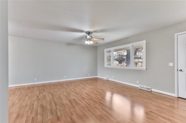 empty room featuring light wood-type flooring and ceiling fan